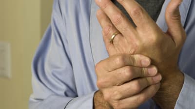 Man holding his hand in pain