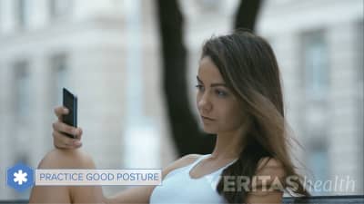 Woman practicing good posture while texting on her phone.