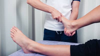 Therapist massaging the foot.