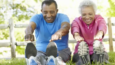 Senior couple stretching outdoors