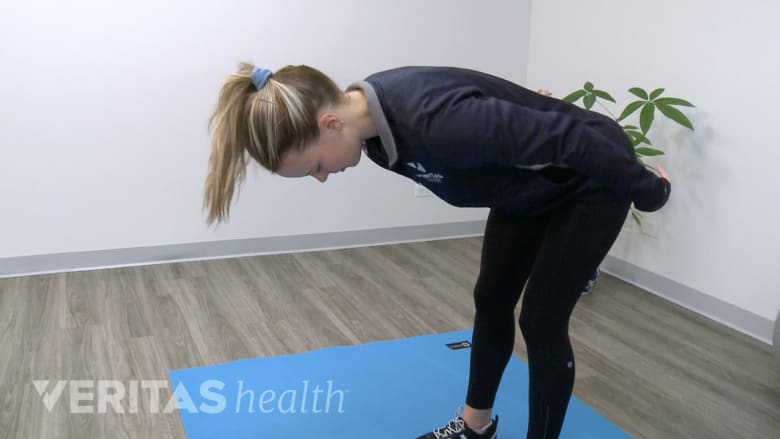 McKenzie method back exercise flexion in standing or beding forward.