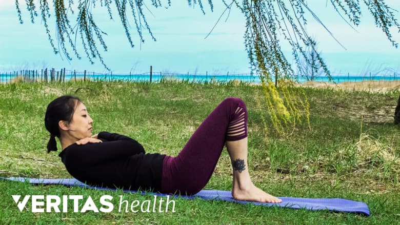 Woman doing a curl up to relieve sciatica pain