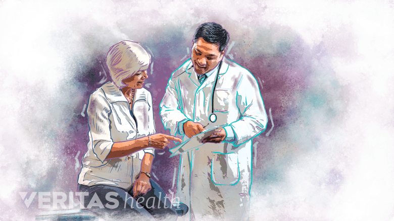 A woman and a doctor looking at a sheet of paper.