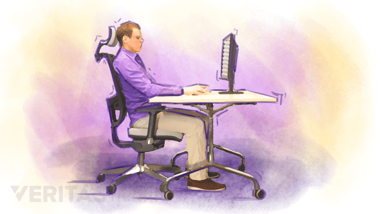 Illustration of a man sitting at a desk with good posture.