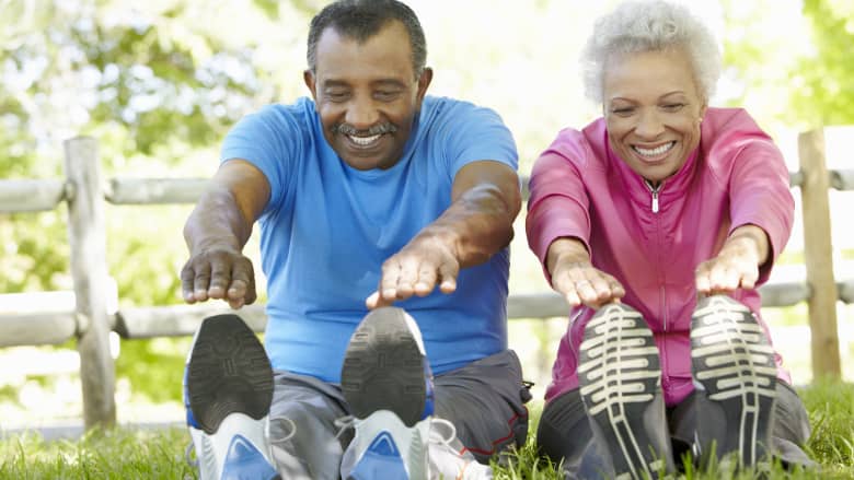 Senior couple stretching outdoors
