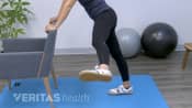 Woman doing a hip swing.