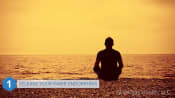 Man releasing his endorphins while sitting on the beach meditating.