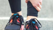 Runner grabbing their shin