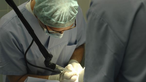 Doctors performing surgery in an operating room