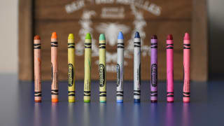 An array of crayons in various colors standing upright, representing the diverse palette creation possible with SASS in web design for color accessibility.