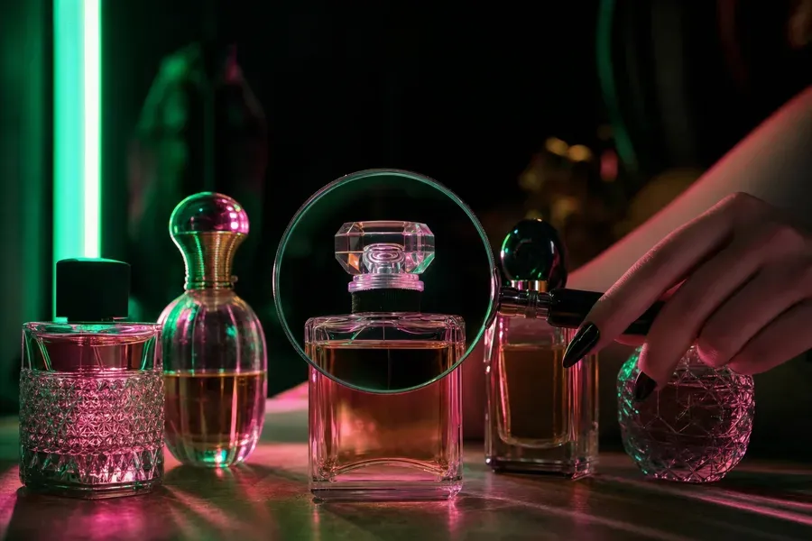 Perfume bottles inspected under a magnifying glass in neon light.