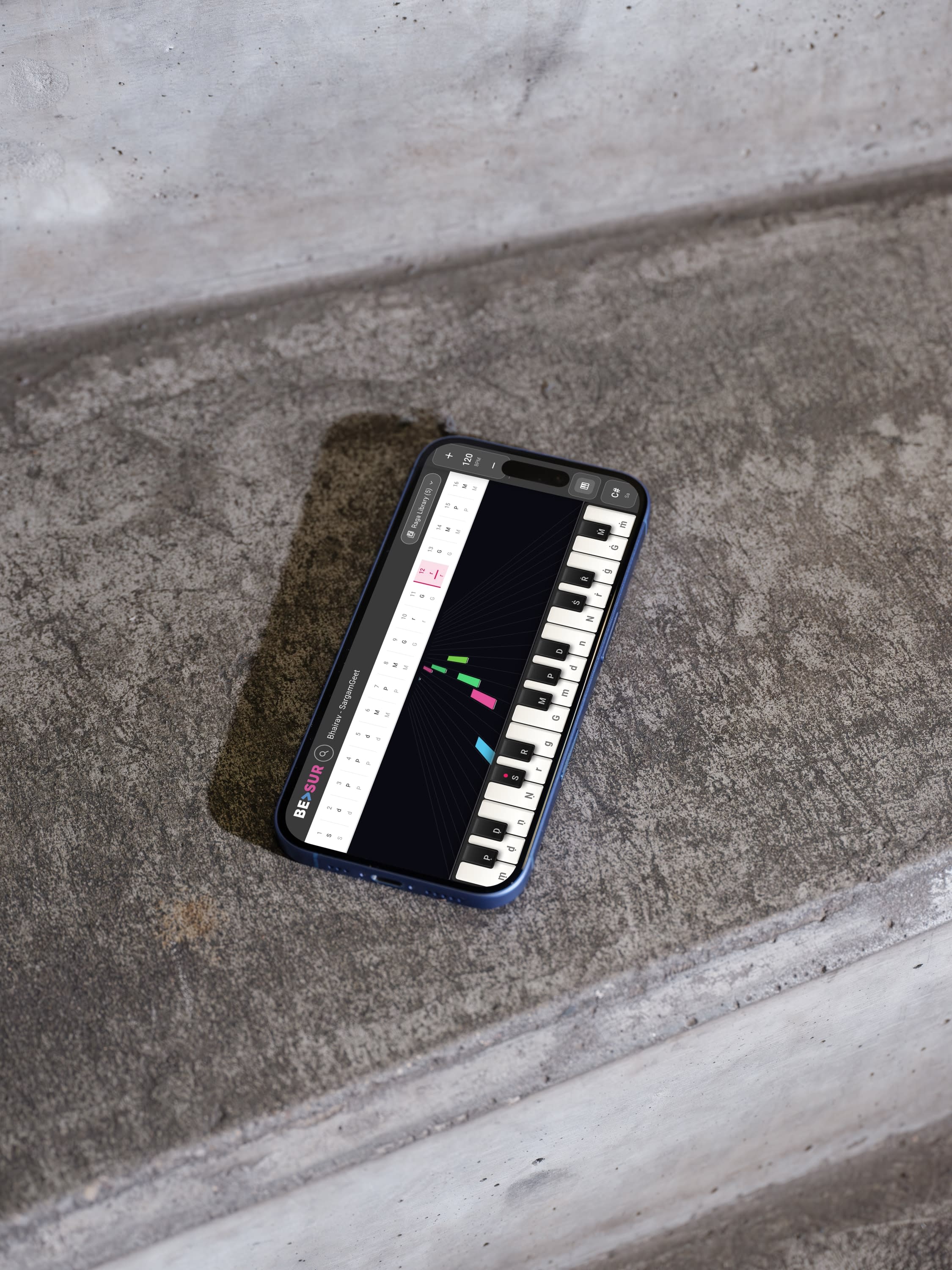 beSur piano interface on iPhone lying on concrete