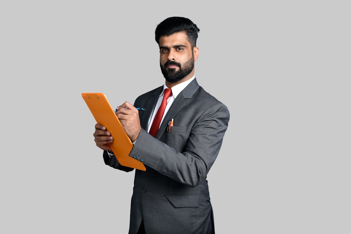 Service business owner reviewing a spreadsheet of leads and enquiries at a desk