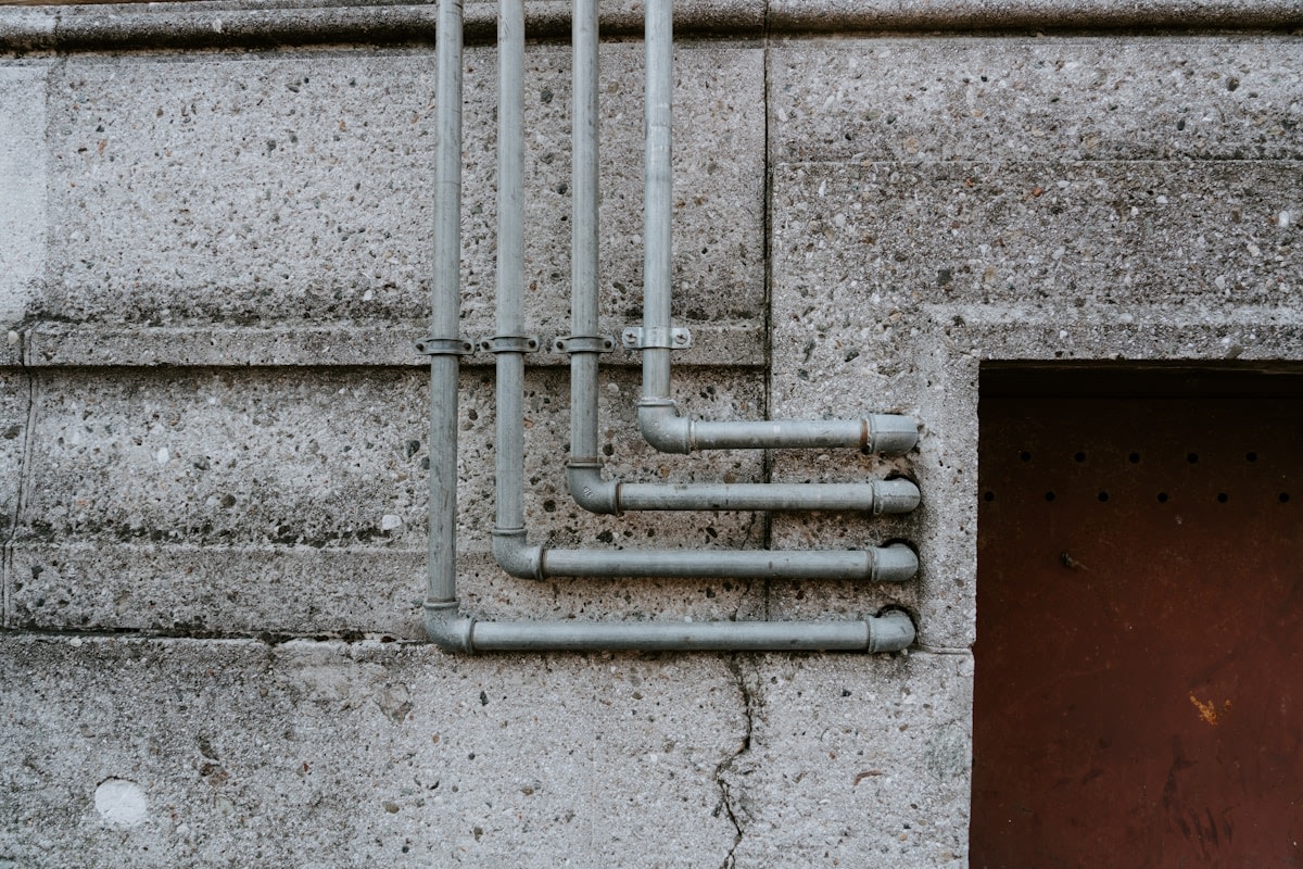 Plumber working on a pipe fitting in a residential property