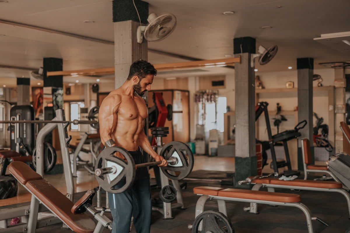 Bright modern gym reception with free weights and member sign-up desk
