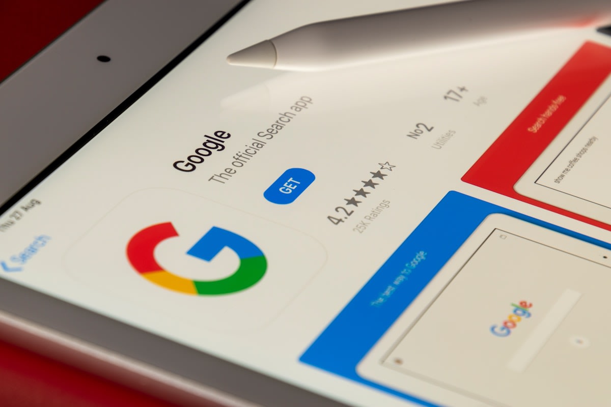 Google Maps local search results shown on a phone held by a tradesperson