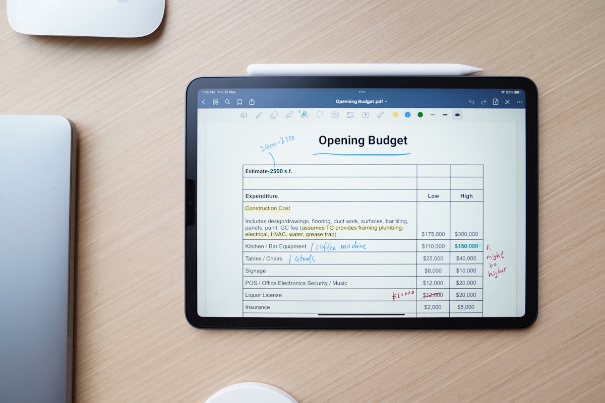 Service business owner managing scheduling across multiple locations on a tablet