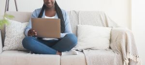 latchel review hero image of woman sitting on laptop sitting on her couch