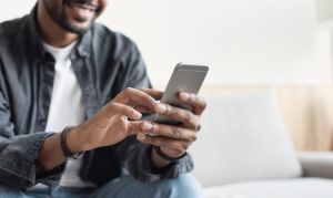 how to find renters online hero image: young man using smartphone