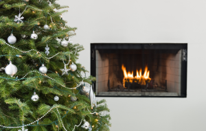 holiday fires image: christmas tree in front of a fireplace