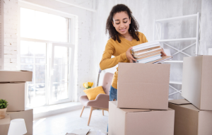 college students image: picture of a young woman putting books into a box