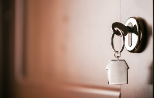rental scams image: key in lock with house keychain