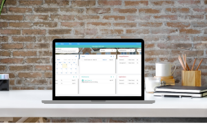 rentredi demo image: picture of a laptop on a desk with a screencapture of the rentredi demo dashboard