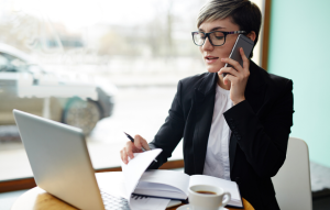 RentTech Image: business woman on phone in front of a laptop