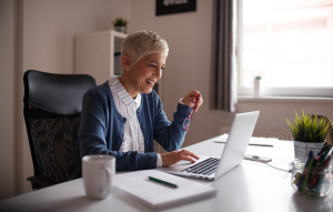older woman on laptop for rentredi auto-tenant screening post