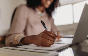 how to be a good landlord : woman writing notes while sitting at her desk
