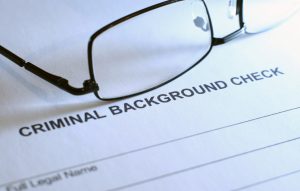 tenant background checks image: picture of glasses sitting on top of a paper that says criminal background check