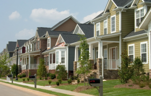 loans for real estate investors image of colorful houses along a neatly trimmed street
