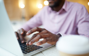 rentredi vs tenantcloud: business man's hands typing on laptop