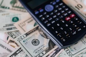 refinance a rental property image of cash and calculater