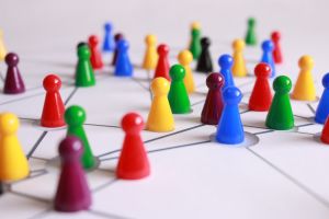 real estate investing team: colorful game pieces on a board