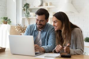rentredi vs zillow rental manager: image of happy young couple on their laptop