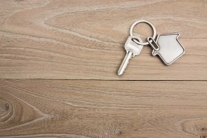 hero image for what are squatters rights blog post: sHouse-shaped key on a wood panel