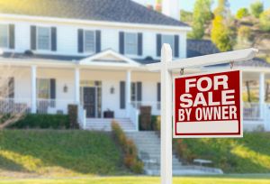 Questions to Ask When Buying a Rental Property hero image: photo of a big white house with a red for sale sign in the foreground