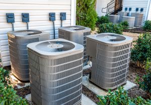 hvac mistakes hero image: picture of four havac units sitting outside a houce