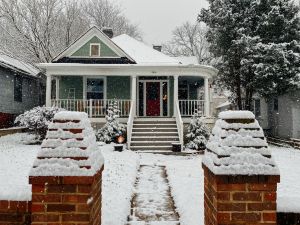 prepare rental for winter: snow covered house with a snowy walkway