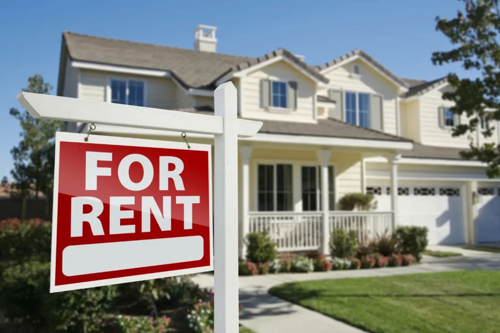 rental listing suburban family home with red for rent sign in front yard on sunny day
