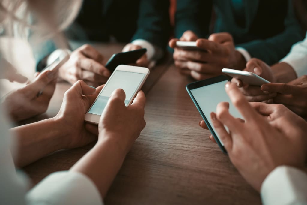 Accounting tools for property managers illustrated by group using smartphones for real-time property and finance coordination.