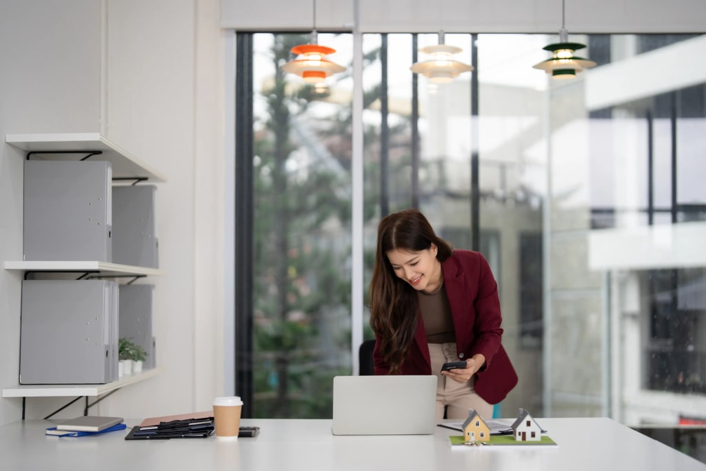 Best accounting software for property management shown by landlord reviewing portfolio data on laptop in modern office.