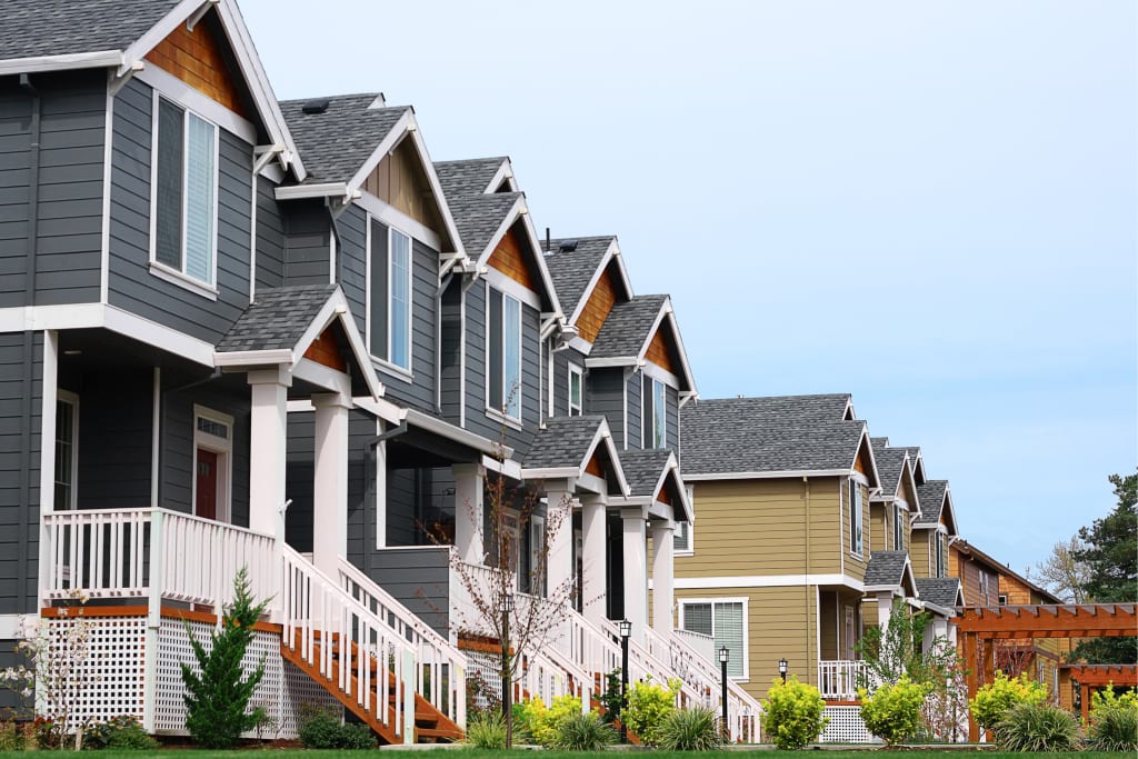 Real estate maintenance shown as a row of modern suburban homes with well-kept exteriors and landscaping.