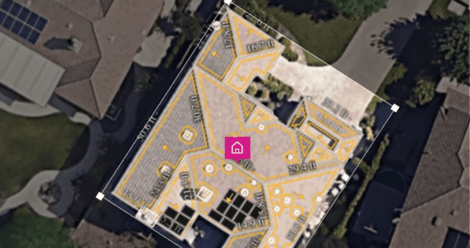 An aerial view of a house roof marked up with survey measurements