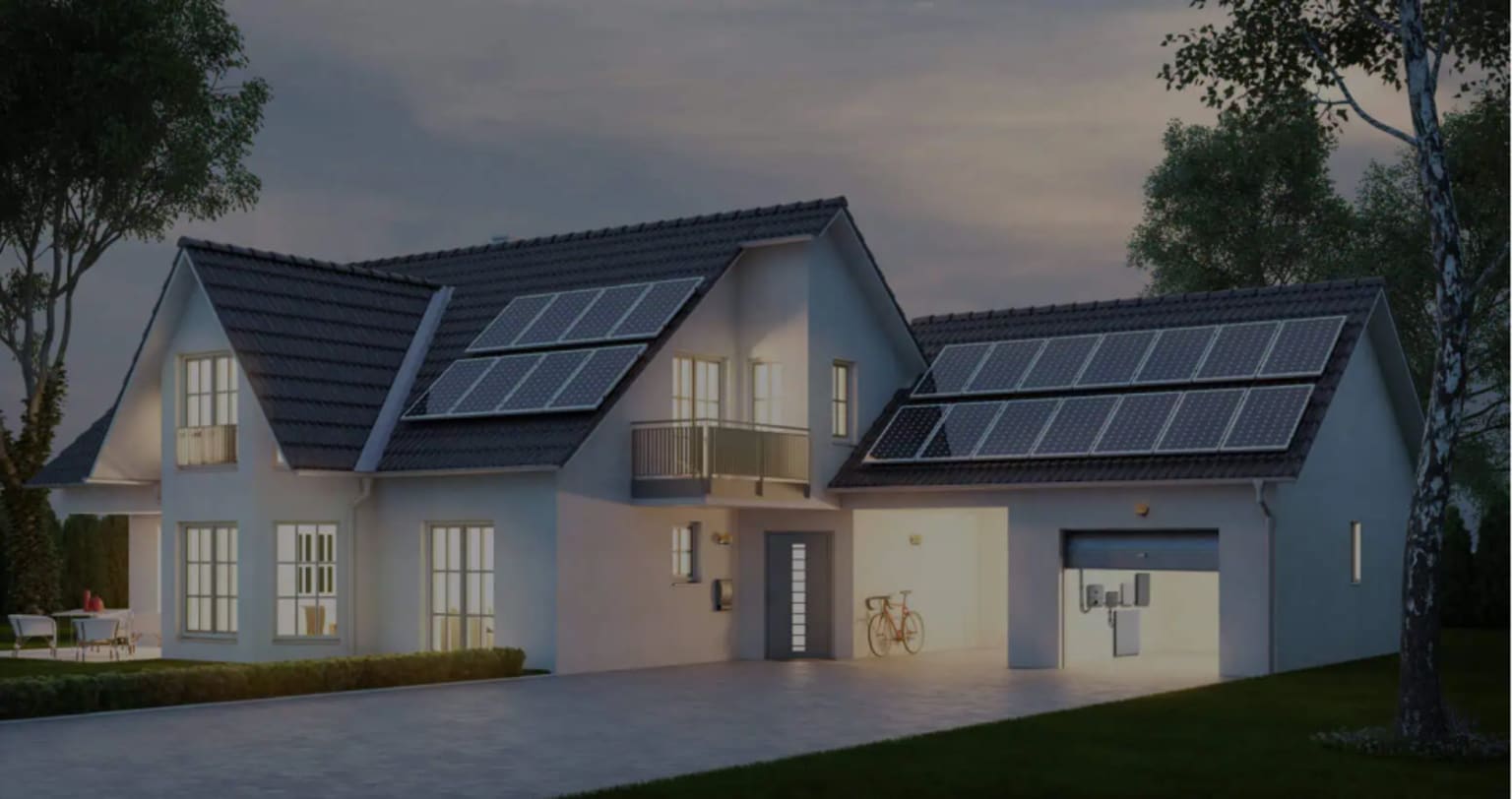 A house at dusk with solar panels fitted across its roof