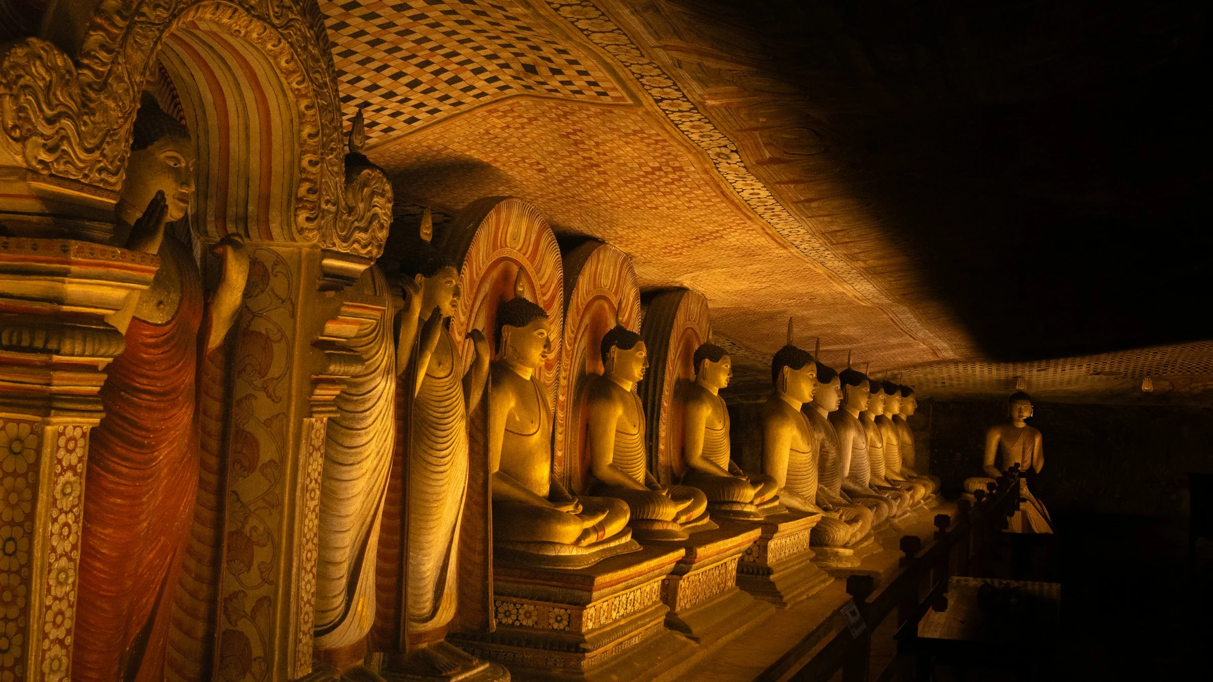A row of Buddha statues in a temple