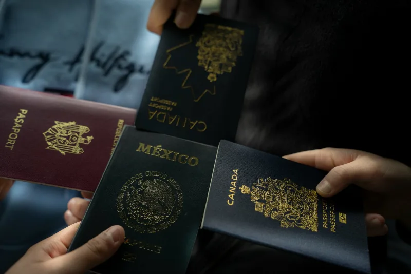 Four people holding a passport