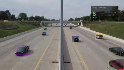 Highway traffic footage with tracked vehicles and a live analytics HUD overlay