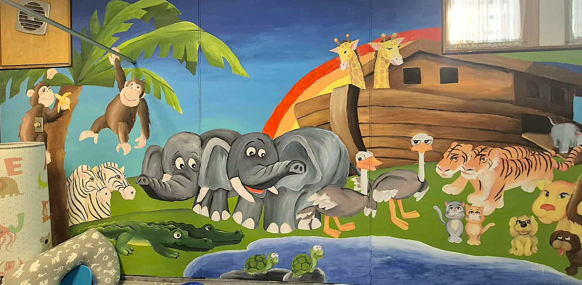 Collaborative mural done on a wall in the BBC Nursery featuring Noah's Ark.